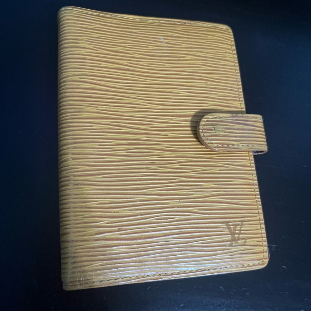 Louis Vuitton small agenda. With some peeling in the pockets.